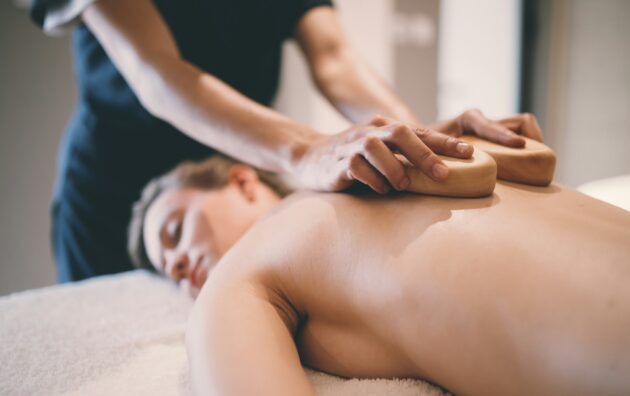 Thai massage therapist treating patient