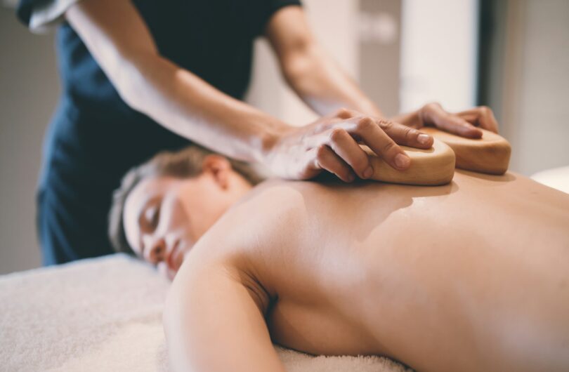 Thai massage therapist treating patient