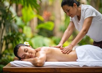 Kvinde får regelmæssig thaimassage med blide tryk og stræk i roligt, naturligt miljø
